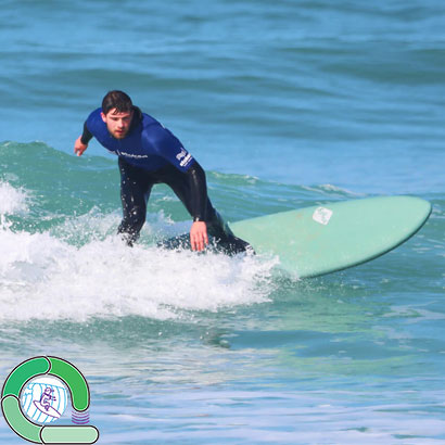A surfer riding green waves, as per the Green Loop from The Loop Surfing Ability Measure