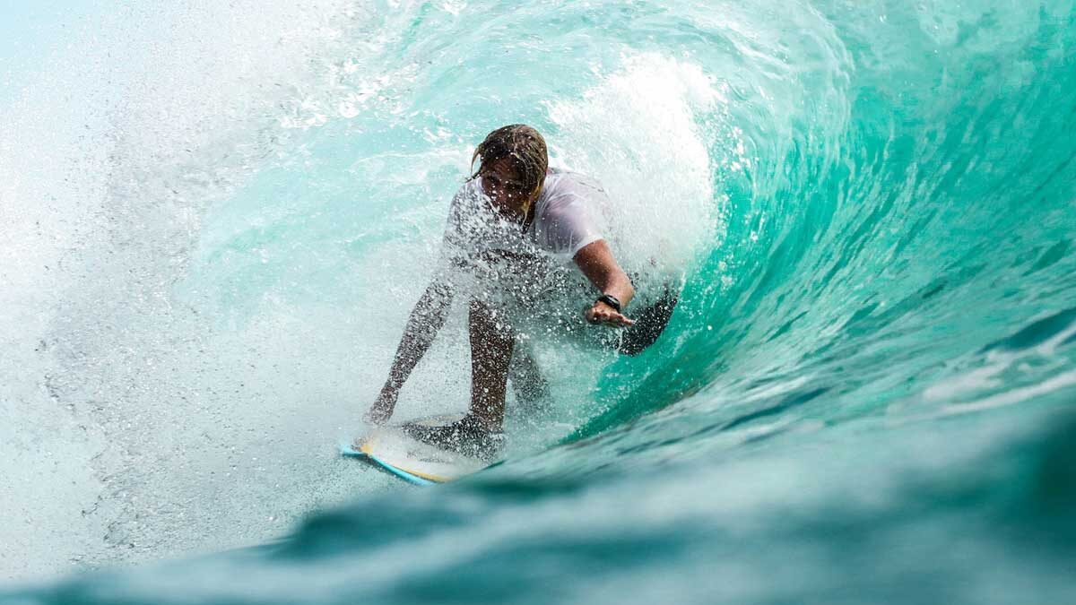 A surfer inside of a wave