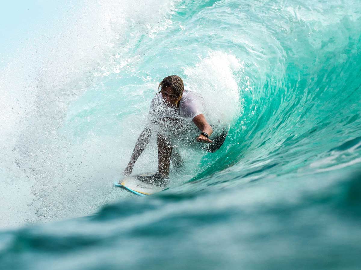 A surfer inside of a wave