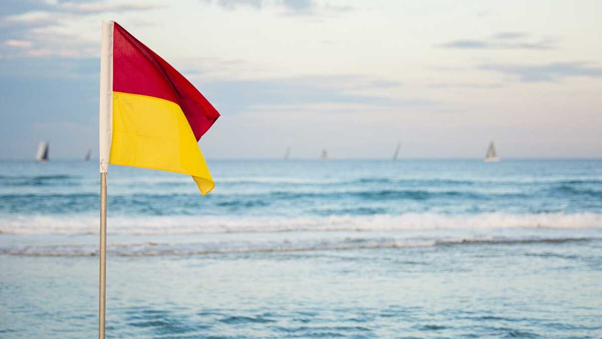 A red and yellow beach flag, showing where it is safe to enter the ocean
