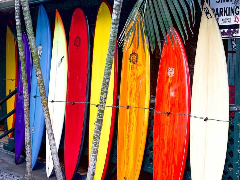 A rack of different types of surfboards