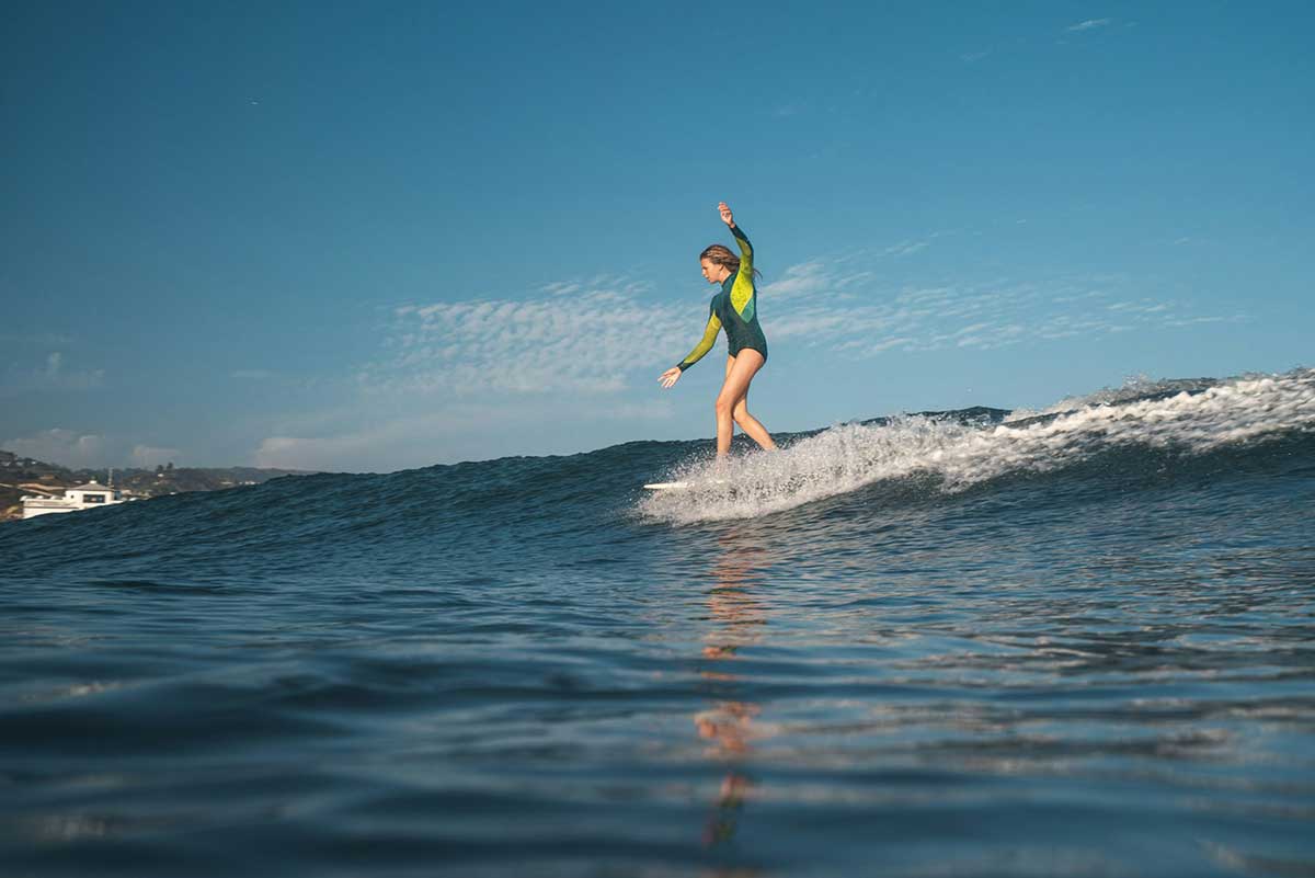 A young female surfer riding a wave