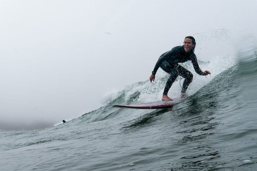 A happy surfer riding a wave