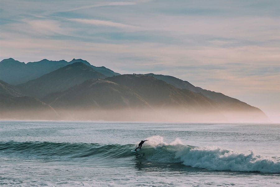 A lone surfer riding a wave