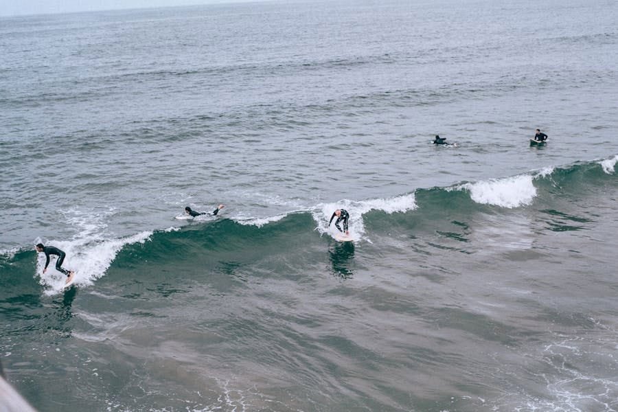 People riding a wave in Cornwall