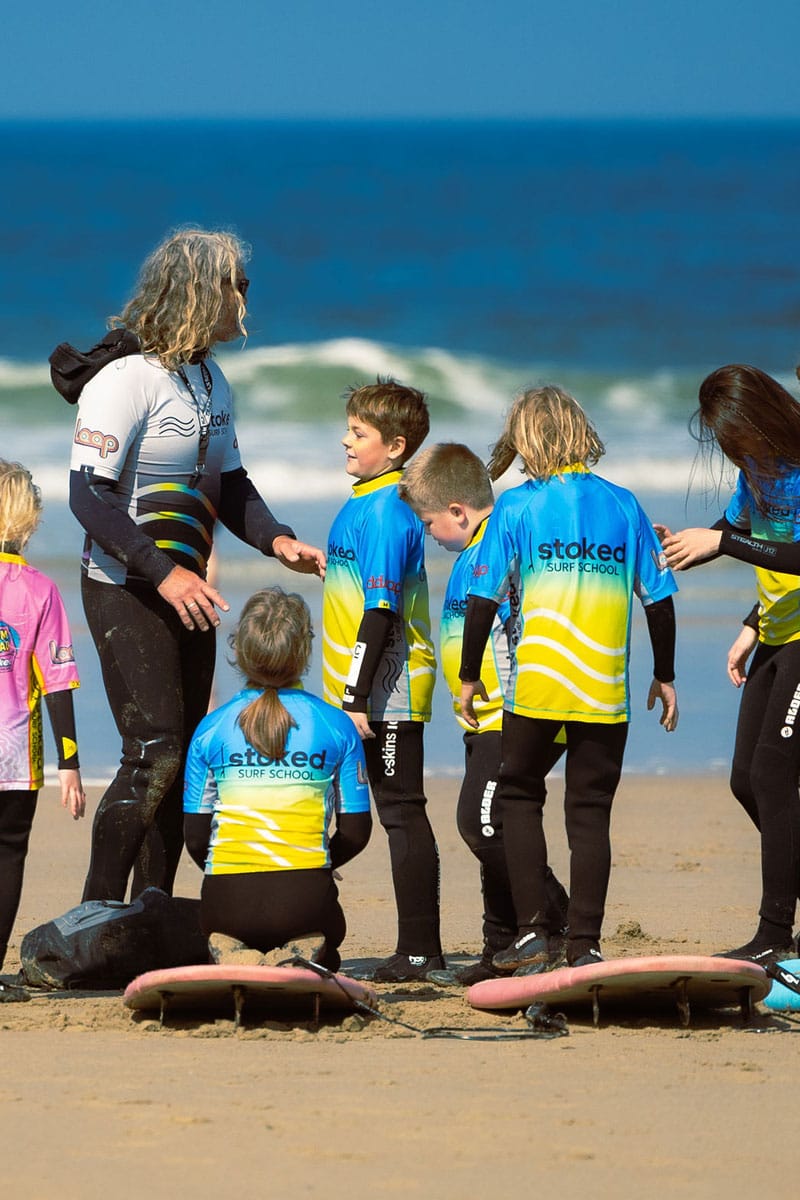 A group of kids, part of the Time2Move program, learning to surf