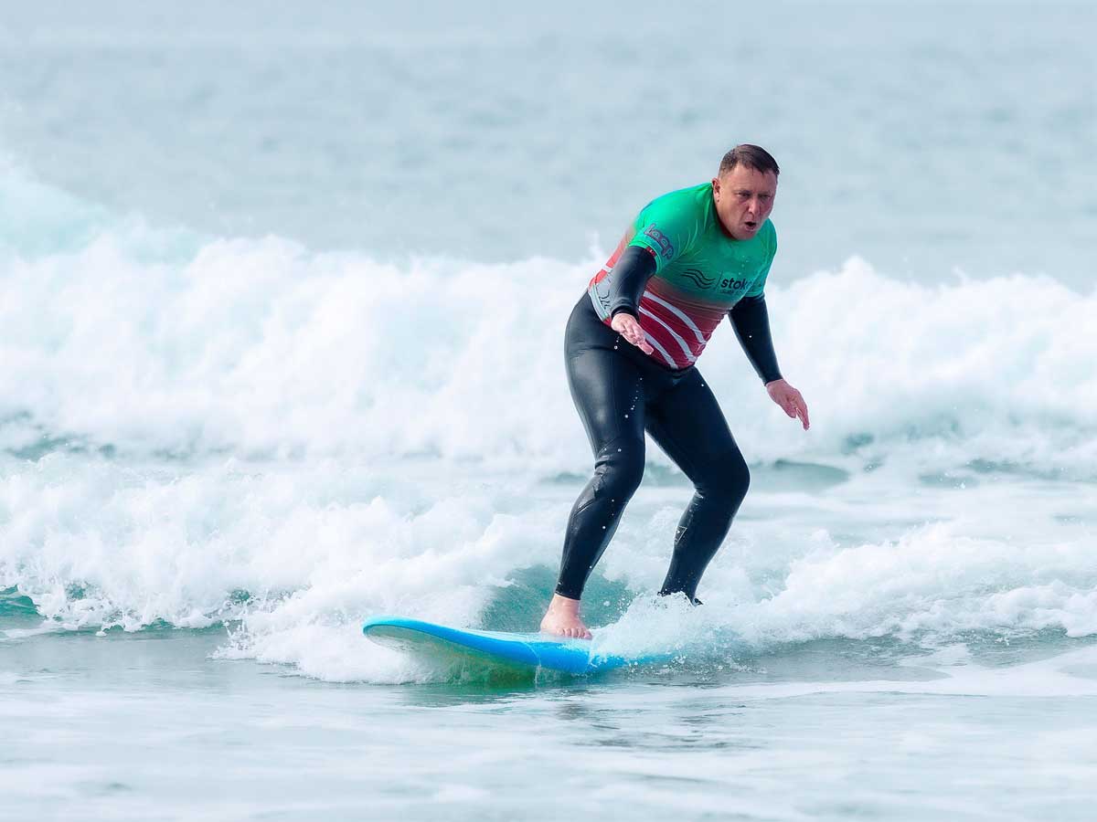 An older man surfing during Father's day 2026