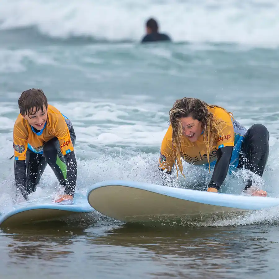 A mum and her son learning to surf with Stoked Surf School