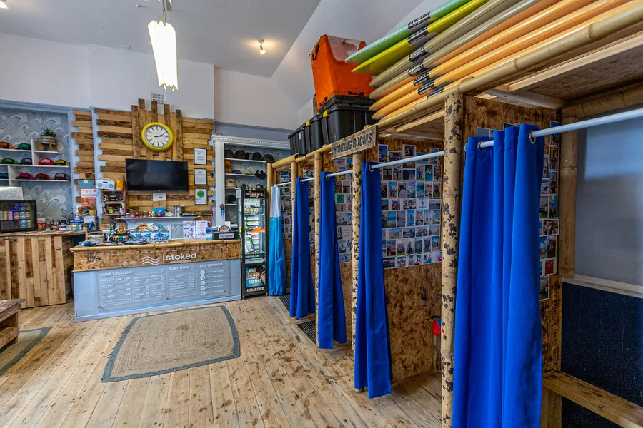 Indoor changing cubicles and board storage at Stoked Surf School